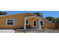 Yellow house with front porch and fenced yard at 2312 22Nd Sw Ave, Largo, FL 33774