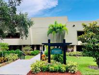Rosemount Lodge 11 building exterior with landscaping and signage at 36750 Us Highway 19 N # 21-302, Palm Harbor, FL 34684