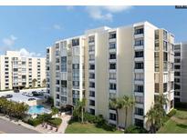 Multi-story building with parking and pool area at 830 S Gulfview Blvd # 601, Clearwater Beach, FL 33767