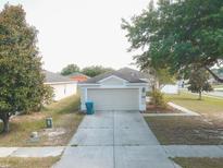 Single-story house with attached garage and a well-maintained yard at 14580 Wake Robin Dr, Brooksville, FL 34604