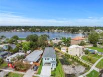 Waterfront home boasting picturesque views, lush landscaping, and a charming light blue exterior at 4234 4Th S St, St Petersburg, FL 33705