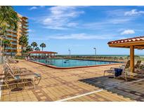 Inviting pool area with lounge chairs and ocean views at 880 Mandalay Ave # S206, Clearwater Beach, FL 33767