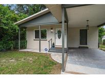House exterior showcasing the front entrance and carport at 6199 59Th N Pl, St Petersburg, FL 33709