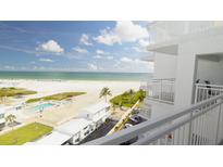 Condo balcony view overlooking the beach, Gulf of Mexico, pool, and manicured grounds at 5830 Midnight Pass Rd # 705, Sarasota, FL 34242