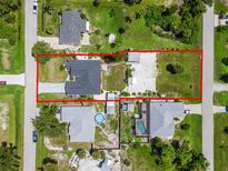 An aerial view shows a property with a well-maintained lawn and clearly defined boundaries at 7162 Benson St, Englewood, FL 34224