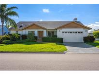 Charming single story home with a two-car garage and lush landscaping at 366 6Th N Ave, Tierra Verde, FL 33715