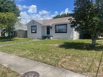 Charming single-story home with a well-maintained front lawn and mature trees on a sunny day at 3301 30Th N Ave, St Petersburg, FL 33713