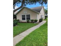 Single story home with landscaped yard and walkway at 2367 N Bentley Dr, Palm Harbor, FL 34684