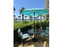 Relaxing patio with table and chairs, offering water views at 5130 Brittany S Dr # 106, St Petersburg, FL 33715
