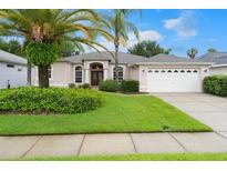 One-story home with attractive landscaping and a two-car garage at 4275 Caliquen Dr, Brooksville, FL 34604