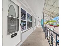 Exterior of condo with unit number 1051, a walkway, and a parking lot at 4071 55Th N Way # 1051, Kenneth City, FL 33709