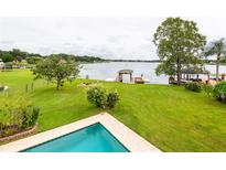 Spacious backyard with a pool, lake view, and private dock at 22607 Southshore Dr, Land O Lakes, FL 34639