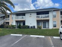 Two-story building with balconies and parking at 455 Alt 19 S # 21, Palm Harbor, FL 34683