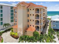 Oceanfront building, featuring terracotta tile roofs and balconies at 19820 Gulf Blvd # 401, Indian Shores, FL 33785