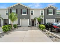 Modern two-story townhome with gray exterior and two-car garage at 2926 Suncoast Plains Dr, Odessa, FL 33556