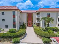 Two-story condo building with red tile roofs at 2612 Pearce Dr # 306, Clearwater, FL 33764