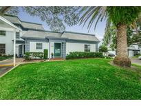 Updated condo with a well-manicured lawn and a charming front entrance at 1211 N Mcmullen Booth Rd # 1211, Clearwater, FL 33759