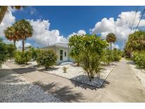 Cute bungalow style home with lush landscaping at 850 Mandalay Ave, Clearwater Beach, FL 33767