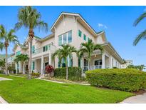 Attractive two-story home with lush landscaping and palm trees at 6 Hibiscus Ln, Belleair, FL 33756
