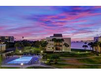 Evening view of community pool and waterfront at 50 Coe Rd # 311, Belleair, FL 33756
