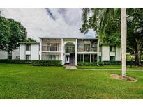 Two-story building with lush landscaping at 1170 Pine Ridge W Cir # C2, Tarpon Springs, FL 34688