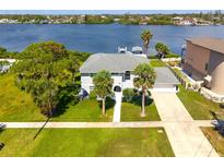 Stunning waterfront home featuring a spacious lawn, mature trees, and private dock at 644 Bayshore Dr, Tarpon Springs, FL 34689