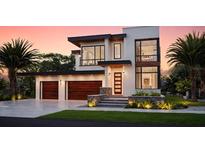 Stunning modern home with a two-car garage, and a beautiful stone accents, providing curb appeal at 705 W Amelia Ave, Tampa, FL 33602