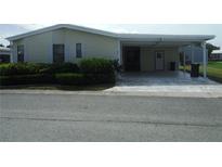 Mobile home with carport and well-maintained landscaping at 231 Tarpon Ln, Oldsmar, FL 34677