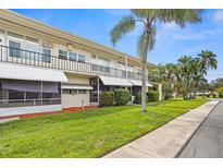 Exterior view of a two-story building with balconies at 4001 58Th N St # 16, Kenneth City, FL 33709