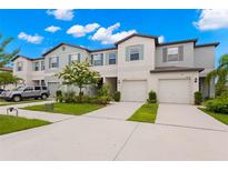 Townhouse exterior with two-car garage and landscaping at 7203 Sweet Alyssum Ct, Tampa, FL 33619