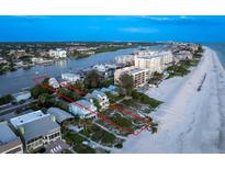 Aerial view of beach house and surrounding area at sunset at 20052 Gulf Blvd, Indian Shores, FL 33785