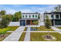 Modern two-story home with a sleek garage, landscaped front yard, and a walkway to the front door at 2721 17Th N Ave, St Petersburg, FL 33713