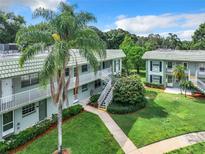 Inviting exterior view of a charming two-story building, surrounded by lush greenery and well-maintained landscaping at 1433 S Belcher Rd # G10, Clearwater, FL 33764