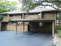 Condo building with carport and landscaping at 201 Cypress Pond Rd # 201, Palm Harbor, FL 34683