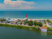 Aerial view of beachfront property, highlighting its location and proximity to the ocean at 74 Gulf Blvd # 2A, Indian Rocks Beach, FL 33785