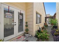 Backyard entry with lush landscaping and a charming walkway at 7518 Clanton Trl, Hudson, FL 34667