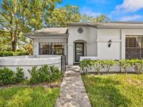 House exterior with manicured lawn and walkway at 3856 Goldfinch Ct, Palm Harbor, FL 34685