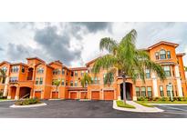 Orange building exterior with palm trees and parking at 2705 Via Murano # 111, Clearwater, FL 33764