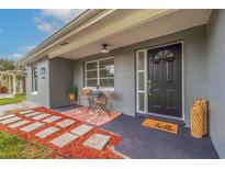 Inviting front porch with sitting area at 6840 Runnel Dr, New Port Richey, FL 34653
