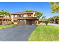 Two-story condo with carport and well-manicured lawn at 4445 Pelorus Dr, New Port Richey, FL 34652