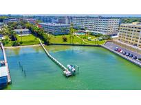Aerial view of waterfront property with boat dock and building at 100 Bluff View Dr # 208B, Belleair Bluffs, FL 33770