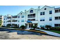 Condo building with attractive exterior and landscaping at 2323 Feather Sound Dr # 202, Clearwater, FL 33762