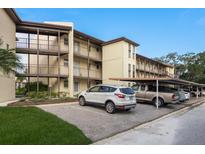 Building exterior showcasing a two-story building with parking at 5245 Amulet Dr # 306, New Port Richey, FL 34652