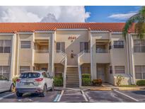 Two-story condo building with tile roof and stairs leading to upper and lower units at 6141 Bahia Del Mar Blvd # 232, St Petersburg, FL 33715