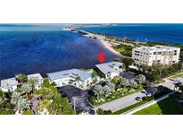 Aerial view showing a waterfront property with a condo building and parking at 2570 Gary Cir # 3, Dunedin, FL 34698