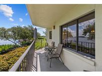 Relaxing balcony overlooking waterfront with table and chairs at 1515 Pinellas Bayway S # 65, St Petersburg, FL 33715