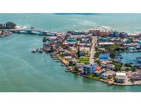 Wide shot of waterfront home near bridge and shops at 447 129Th E Ave, Madeira Beach, FL 33708