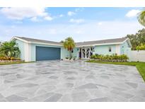 Charming light blue home with a large stone driveway at 5690 Bayview Dr, Seminole, FL 33772