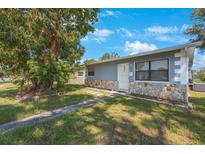 Ranch style home with stone accents and a landscaped yard at 751 90Th N Ave, St Petersburg, FL 33702