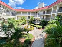 Community courtyard with lush landscaping and a central fountain at 2700 Bayshore Blvd # 3212, Dunedin, FL 34698